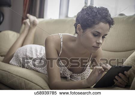 Young woman using digital tablet View Large Photo Image Stock Photography - Young woman using digital tablet. Fotosearch