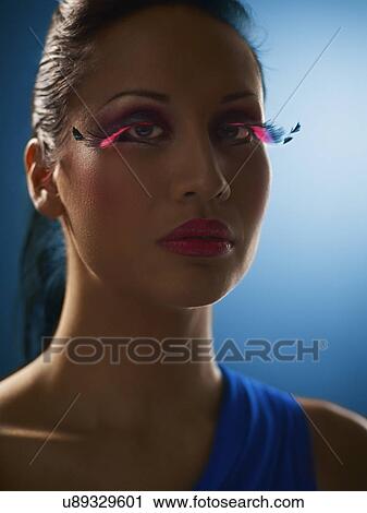 Young woman wearing fake eyelashes View Large Photo Image Stock Image - Young woman wearing fake eyelashes. Fotosearch