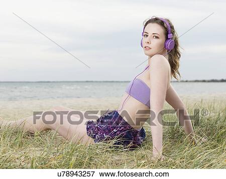 Young woman wearing headphones View Large Photo Image Stock Photo - Young woman wearing headphones. Fotosearch