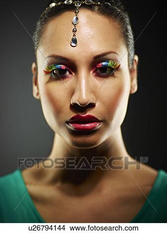 Young woman with jewel head accessory and coloured eyelashes View Large Photo Image Picture - Young woman with jewel head accessory and coloured eyelashes. Fotosearch