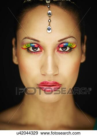 Young woman with jewel head accessory and coloured eyelashes View Large Photo Image Stock Photo - Young woman with jewel head accessory and coloured eyelashes. Fotosearch
