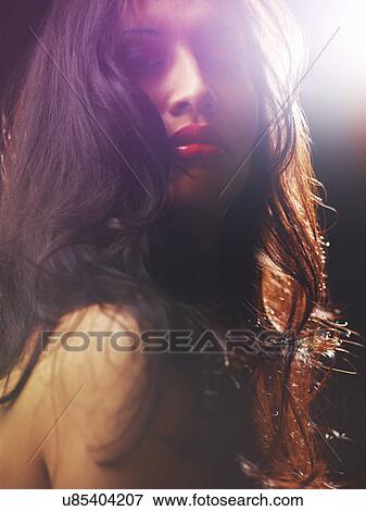 Young woman with long brown hair, backlit View Large Photo Image Stock Photo - Young woman with long brown hair, backlit. Fotosearch