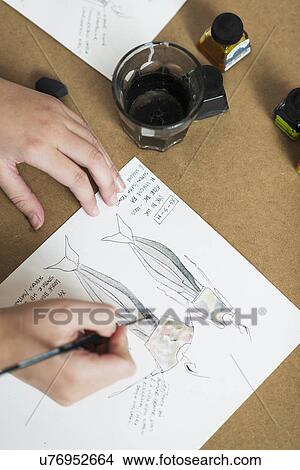 Young womans hands painting fashion design on work table View Large Photo Image Picture - Young womans hands painting fashion design on work table. Fotosearch