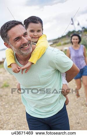 Father giving daughter piggyback View Large Photo Image Stock Photo - Father giving daughter piggyback. Fotosearch