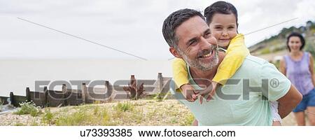 Stock Photography - Father giving daughter piggyback. Fotosearch