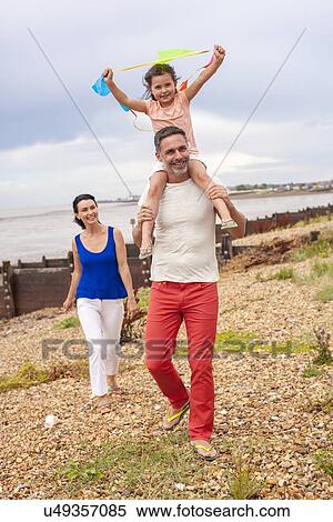 Stock Photography - Father on beach with daughter. Fotosearch