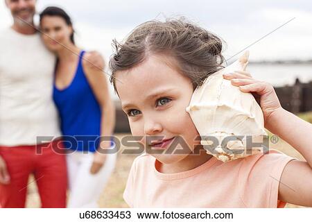 Stock Image - Girl with seashell. Fotosearch