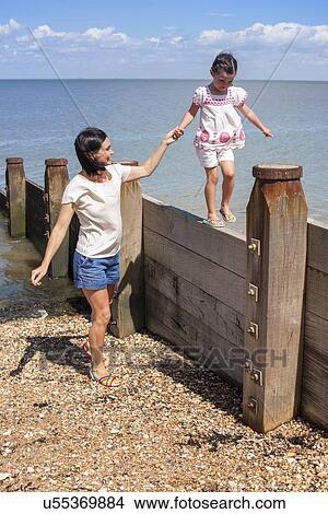 Picture - Mother and daughter on beach. Fotosearch