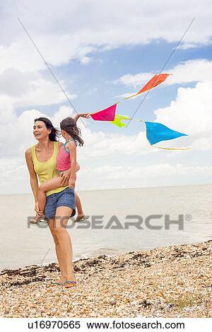 Stock Photography - Mother and daughter on beach. Fotosearch