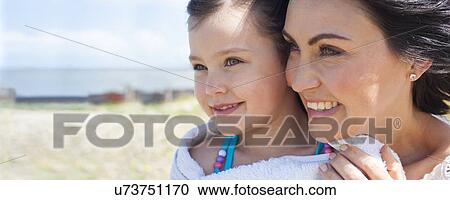 Stock Image - Mother and daughter smiling. Fotosearch