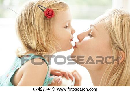 Stock Photo - Mother kissing daughter. Fotosearch