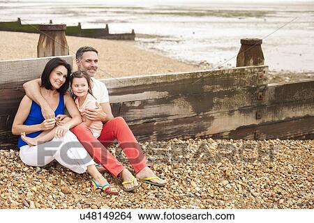Picture - Parents on beach with daughter. Fotosearch