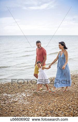 Parents on beach with daughter View Large Photo Image Stock Image - Parents on beach with daughter. Fotosearch