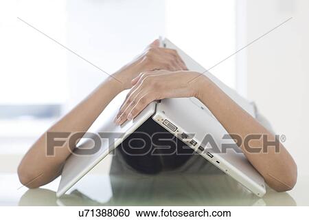 Stock Image - Woman and laptop over her head. Fotosearch