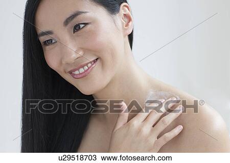 Woman applying body cream View Large Photo Image Stock Image - Woman applying body cream. Fotosearch