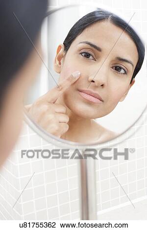 Woman applying face cream View Large Photo Image Stock Image - Woman applying face cream. Fotosearch