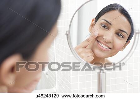 Woman applying face cream View Large Photo Image Stock Photo - Woman applying face cream. Fotosearch