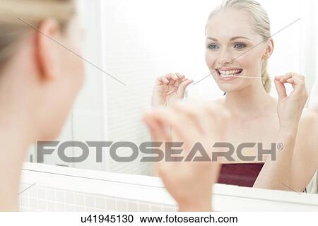 Woman flossing her teeth View Large Photo Image Stock Image - Woman flossing her teeth. Fotosearch