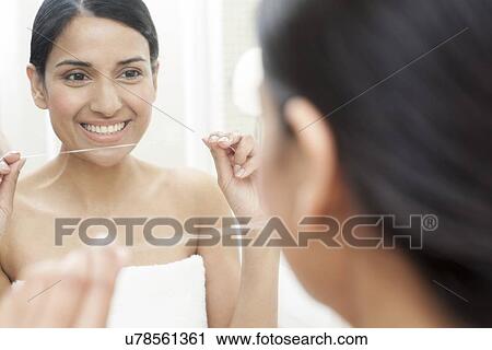 Woman flossing her teeth View Large Photo Image Stock Image - Woman flossing her teeth. Fotosearch