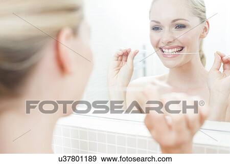 Woman flossing her teeth View Large Photo Image Stock Photo - Woman flossing her teeth. Fotosearch