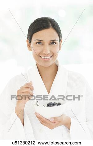 Woman holding bowl of fruit and spoon View Large Photo Image Stock Image - Woman holding bowl of fruit and spoon. Fotosearch