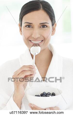 Woman holding bowl of fruit and spoon View Large Photo Image Stock Photo - Woman holding bowl of fruit and spoon. Fotosearch