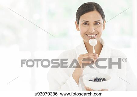Woman holding bowl of fruit and spoon View Large Photo Image Stock Photograph - Woman holding bowl of fruit and spoon. Fotosearch