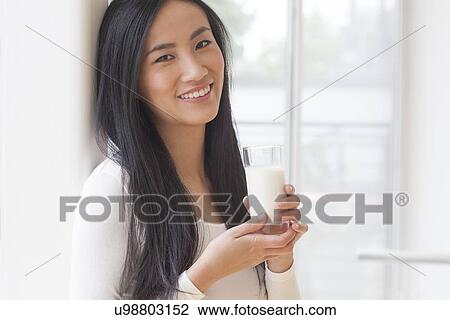 Woman holding glass of milk View Large Photo Image Stock Image - Woman holding glass of milk. Fotosearch
