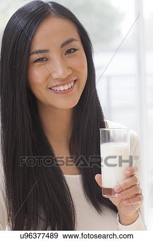Stock Photo - Woman holding glass of milk. Fotosearch