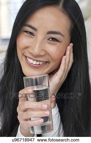 Stock Photo - Woman holding glass of water. Fotosearch
