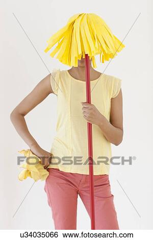 Woman holding mop in front of face View Large Photo Image Stock Photograph - Woman holding mop in front of face. Fotosearch