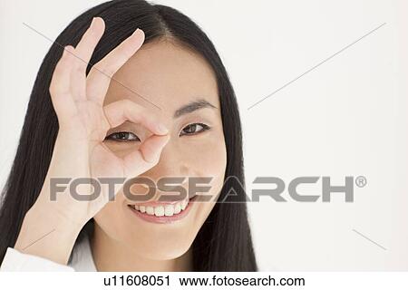 Woman looking through fingers View Large Photo Image Stock Image - Woman looking through fingers. Fotosearch