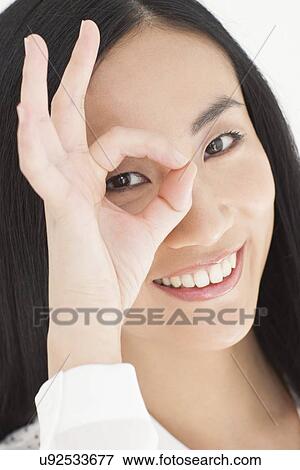 Woman looking through fingers View Large Photo Image Stock Photo - Woman looking through fingers. Fotosearch