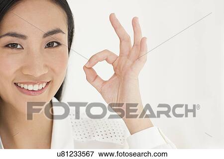 Stock Photo - Woman making ok sign. Fotosearch