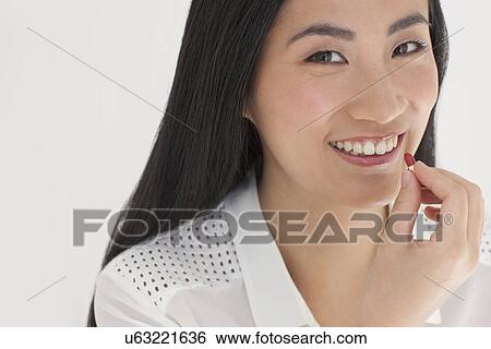 Stock Photograph - Woman taking tablet. Fotosearch