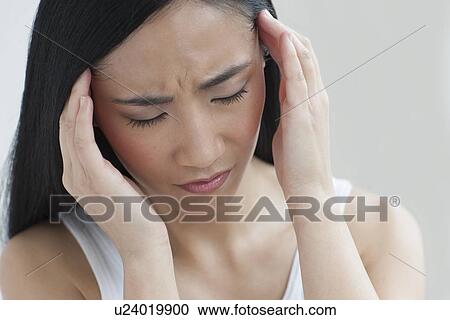 Stock Image - Woman touching head. Fotosearch