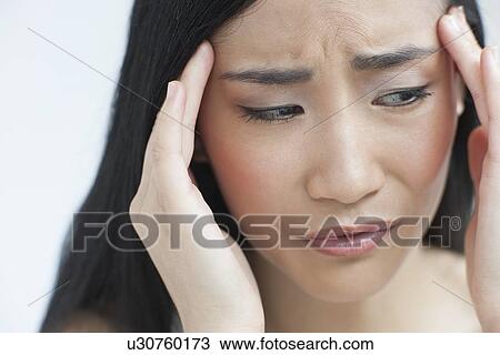 Stock Image - Woman touching head. Fotosearch