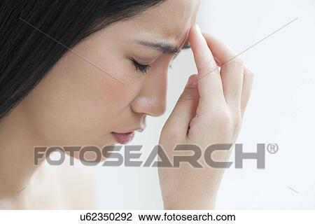 Stock Image - Woman touching head. Fotosearch
