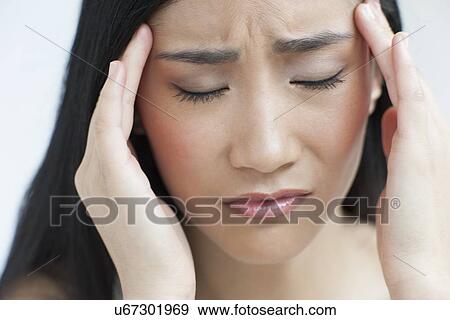 Stock Photo - Woman touching head. Fotosearch