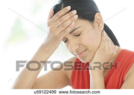 Woman touching her head and neck View Large Photo Image Stock Photo - Woman touching her head and neck. Fotosearch