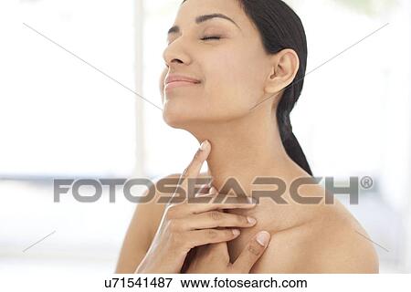 Stock Photo - Woman touching her neck. Fotosearch