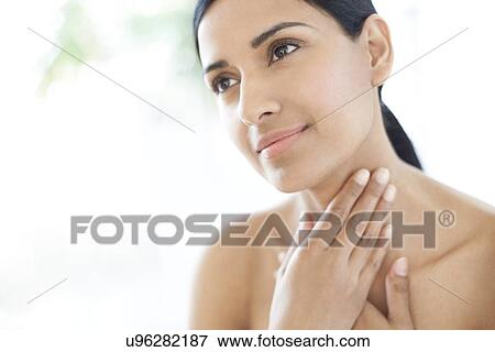 Stock Photo - Woman touching her neck. Fotosearch