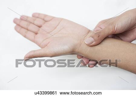 Woman touching her wrist View Large Photo Image Stock Image - Woman touching her wrist. Fotosearch