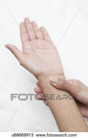 Woman touching her wrist View Large Photo Image Stock Image - Woman touching her wrist. Fotosearch