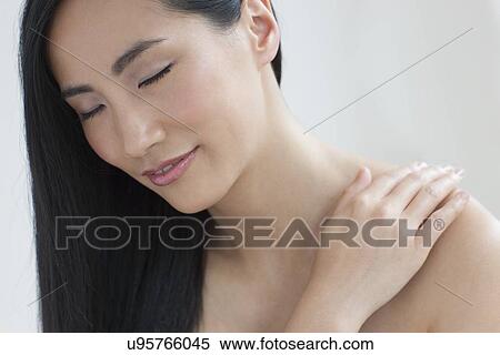 Stock Photography - Woman touching shoulder. Fotosearch