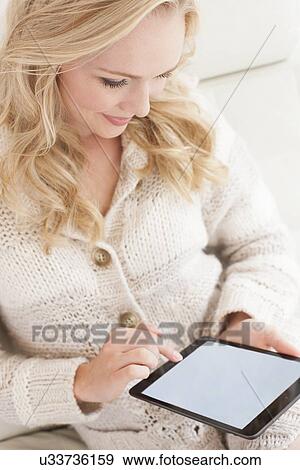 Woman using digital tablet View Large Photo Image Stock Photo - Woman using digital tablet. Fotosearch