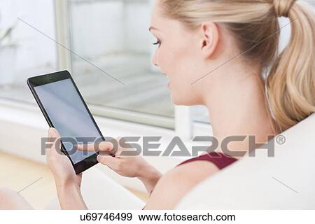 Woman using digital tablet View Large Photo Image Stock Photo - Woman using digital tablet. Fotosearch