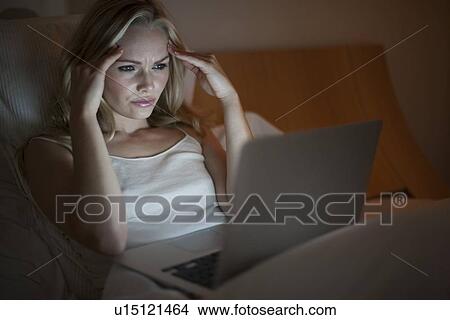 Picture - Woman using laptop. Fotosearch