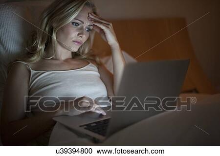 Stock Image - Woman using laptop. Fotosearch