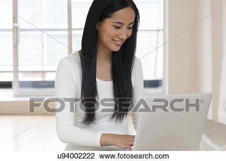 Woman using laptop View Large Photo Image Stock Image - Woman using laptop. Fotosearch